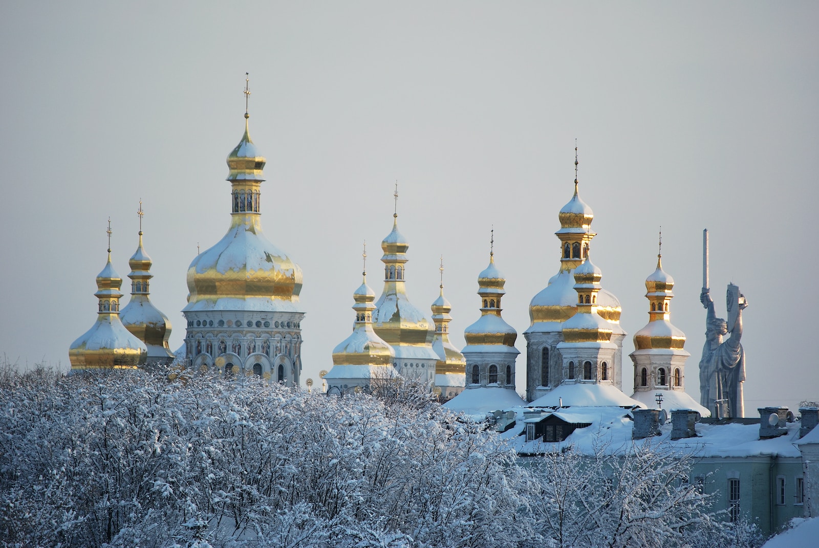 white and gold dome building covered with snow