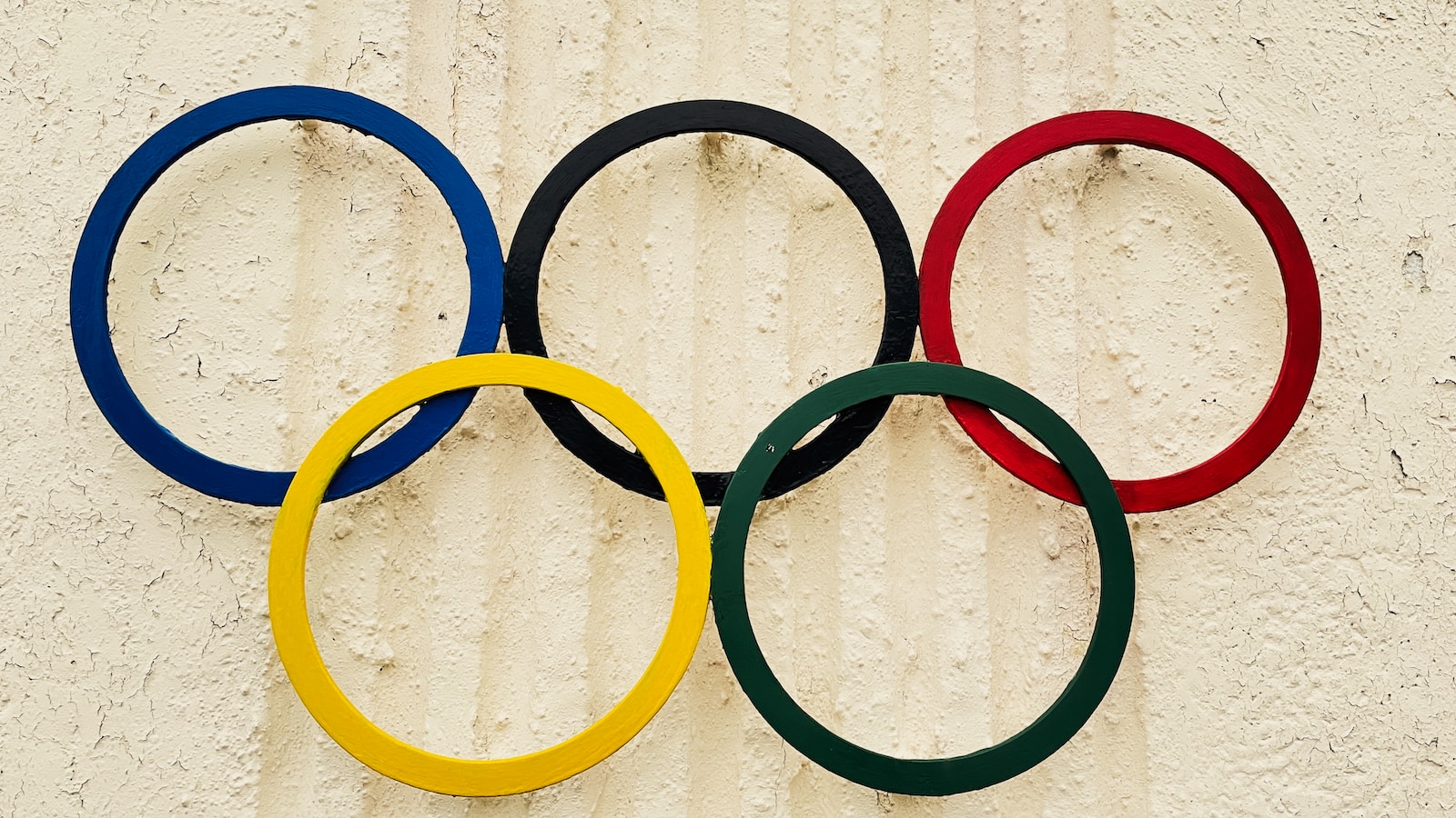 a close up of the olympic rings on a wall